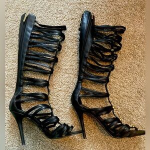 Black, Leather, front Gold-studded, gladiator-style heeled boots.